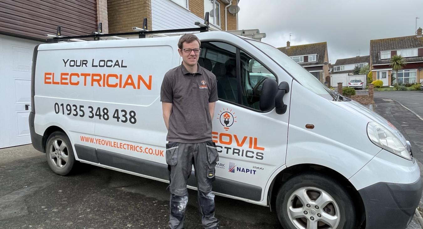 Electrician in Yeovil: Ben standing in front of his work van